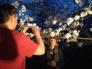 Dad taking a pic of mum posing by cherry blossom