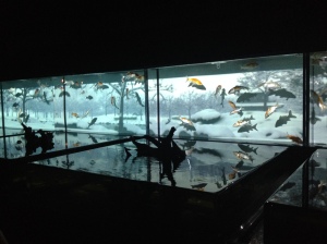 The four seasons aquarium that has a projection of the changing seasons behind it.